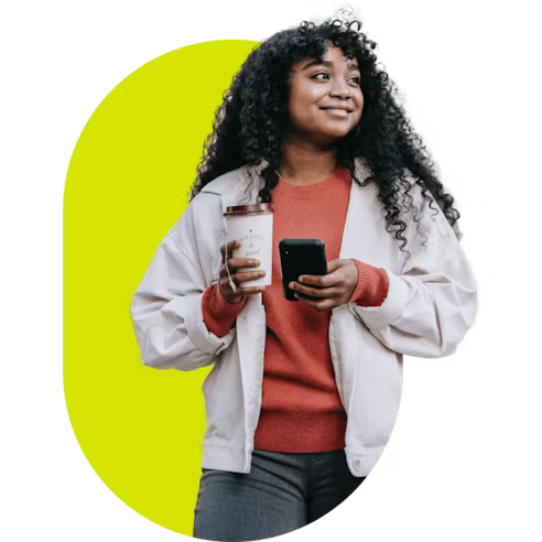 Person holding a phone and coffee cup.