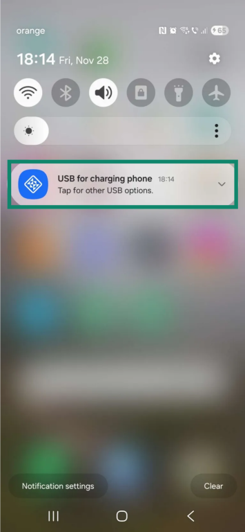 The home screen on an Android phone. The "USB for charging phone" notification is in focus and highlighted.